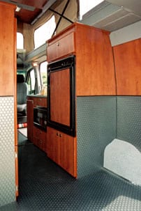 This custom Sportsmobile Sprinter conversion features a galley with a microwave.
