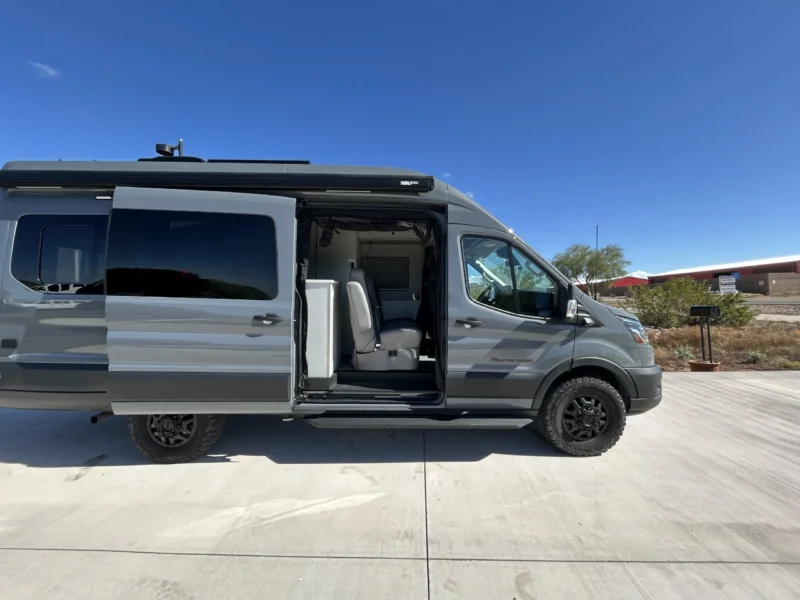 2024 Ford Transit 350 148 High Roof AWD, passenger-side profile with sliding door open and BFGoodrich KO2 tires