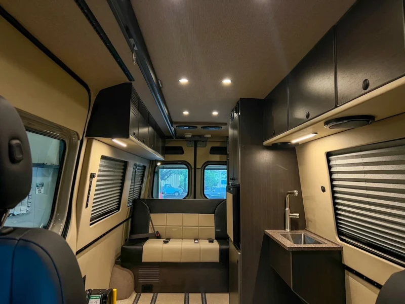 2026 Mercedes Sprinter 170 High Roof AWD Wheelchair Accessible, interior, looking rear, sofa and sink cabinet