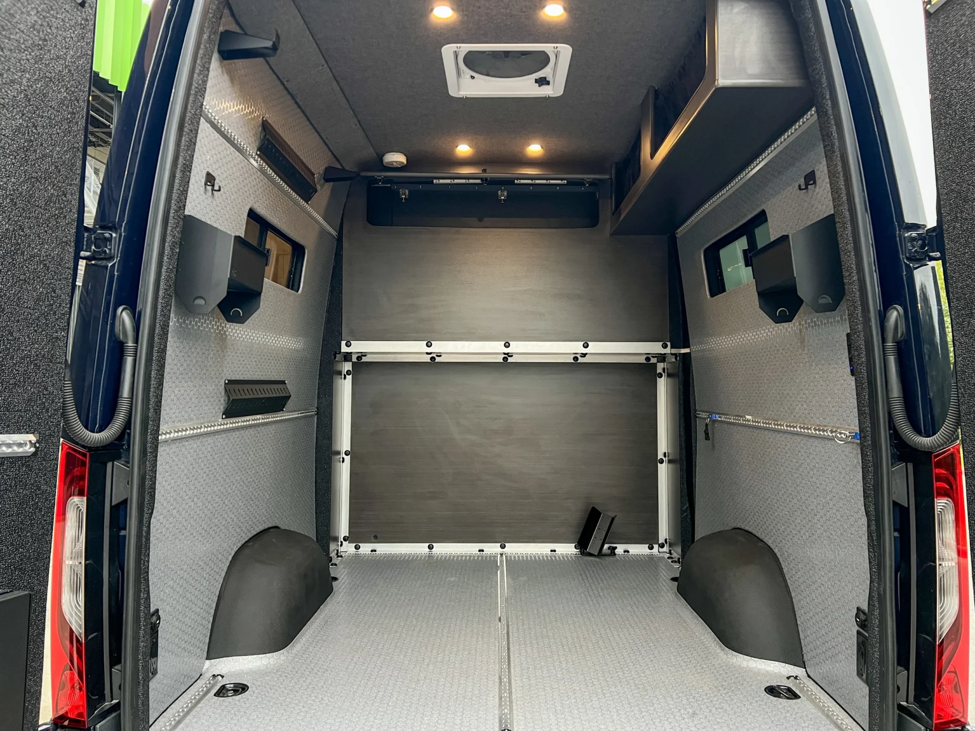 Mercedes Sprinter 2500 144 High Roof AWD Motorcycle Hauler and Front Sitting Area, garage looking forward to the partition wall