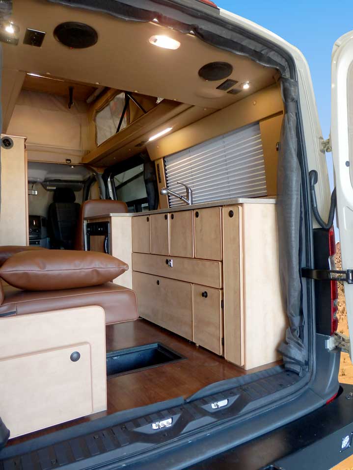 Transit camper conversion rear view of open storage space.