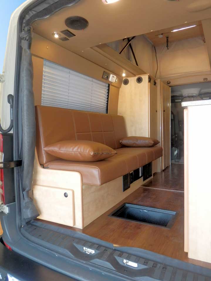 Transit camper conversion interior view of storage space under the gaucho.