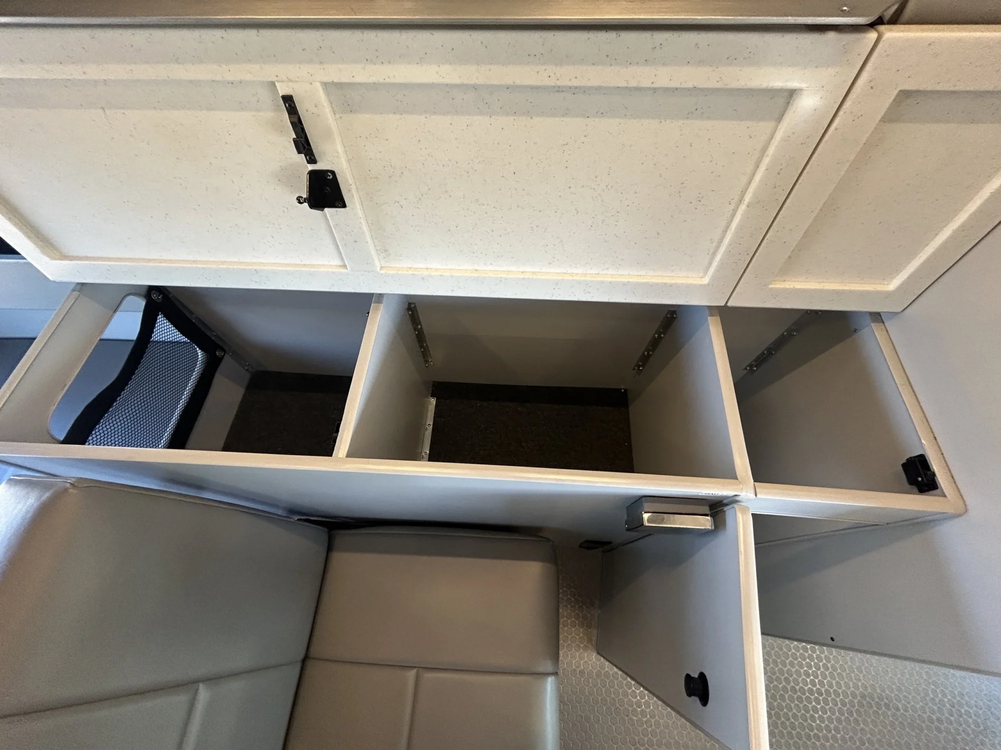 2024 Ford Transit 350 148 High Roof AWD, open passenger-side storage compartments with mesh pocket inside counter