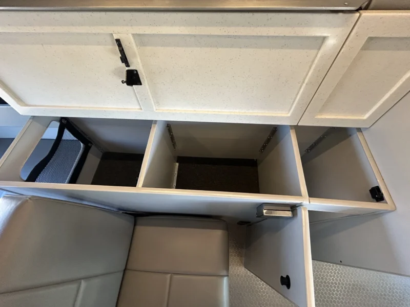 2024 Ford Transit 350 148 High Roof AWD, open passenger-side storage compartments with mesh pocket inside counter