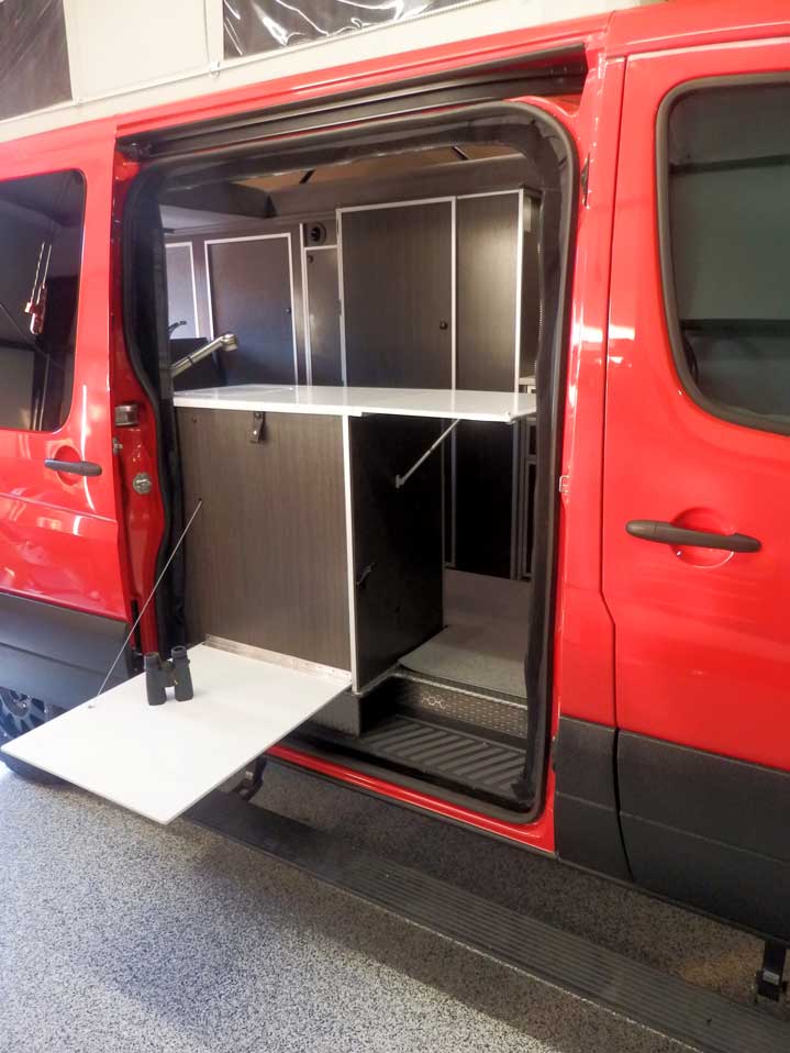 Custom Red RB-50M Sportsmobile Sprinter with outside access to the galley.