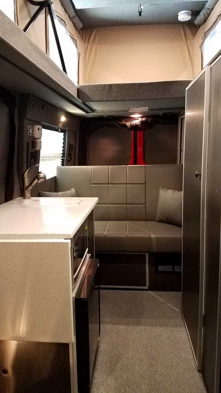 Custom Red RB-50M Sportsmobile Sprinter with leather couch.