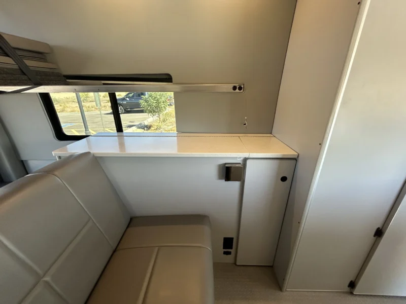 2024 Ford Transit 350 148 High Roof AWD, passenger-side counter, slider window, L-track, and tall rear cabinet