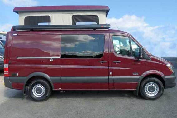 Maroon Sprinter van conversion with penthouse pop top.