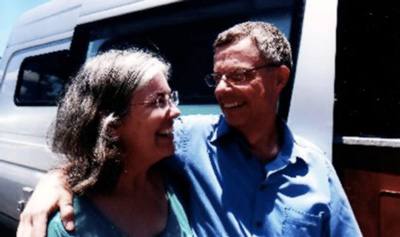 J.H. and Julie Winans are satisfied Sportsmobile conversion van owners standing by their van.