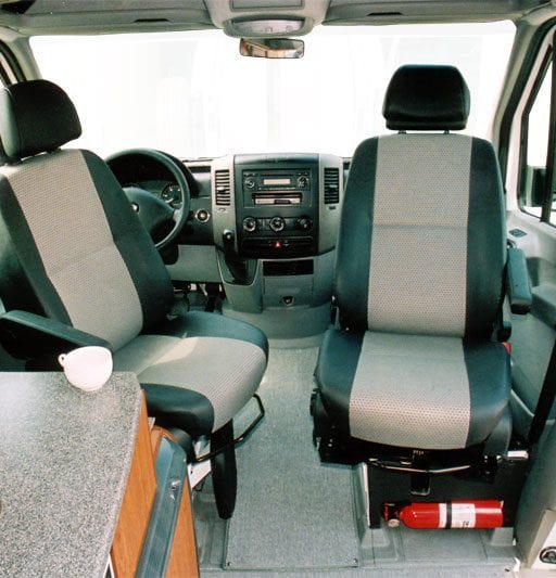 Interior view of Captain seats inside of camper van.