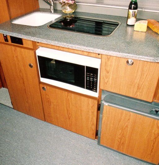 Interior view of kitchen upgrades inside of camper van.