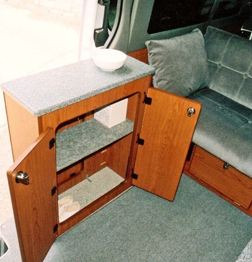 Interior view of cabinets inside of camper van.