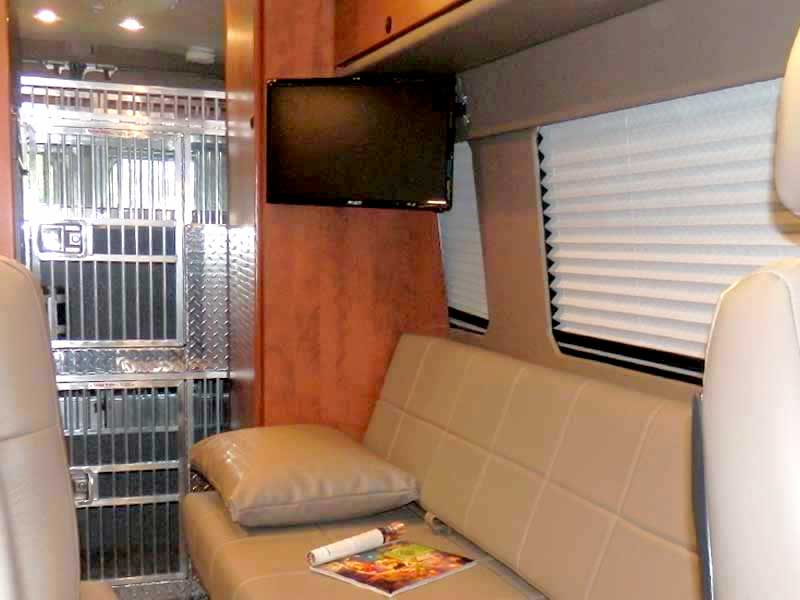 Inside view of Sportsmobile custom camper van outffitted with a sofa and in