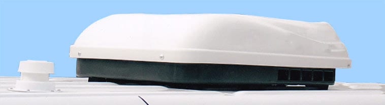 Close up view of a low profile air condition on top of a van conversion.