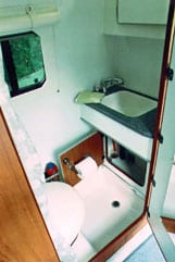 Interior side view of a sink inside a Sportsmobile conversion van.