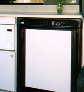 An optional white 4E refrigerator installed under kitchen countertop.