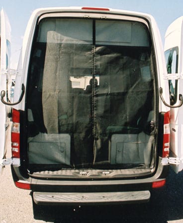 A white custom Sportsmobile van conversion with full height rear door screens installed.