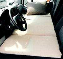 Interior view of a sofa's mattress in a Sportsmobile van conversion.