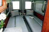 Interior view of a dinettes that are thirty inches wide in a Sportsmobile van conversion.