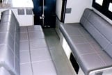 Interior view of a dinette that sleeps width-wise in a Sportsmobile van conversion.