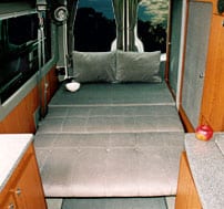 Interior view of a platform mattress in a Sportsmobile van conversion.