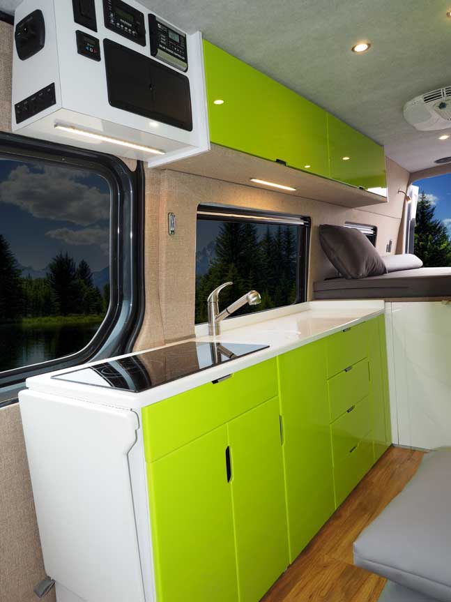 The modern kitchen with a bright green and white color scheme inside a custom Sportsmobile van conversion van.