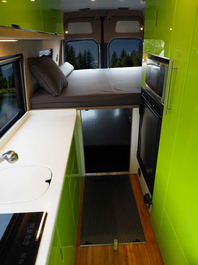 Interior view of a custom Sportsmobile van conversion featuring a removable platform bed.
