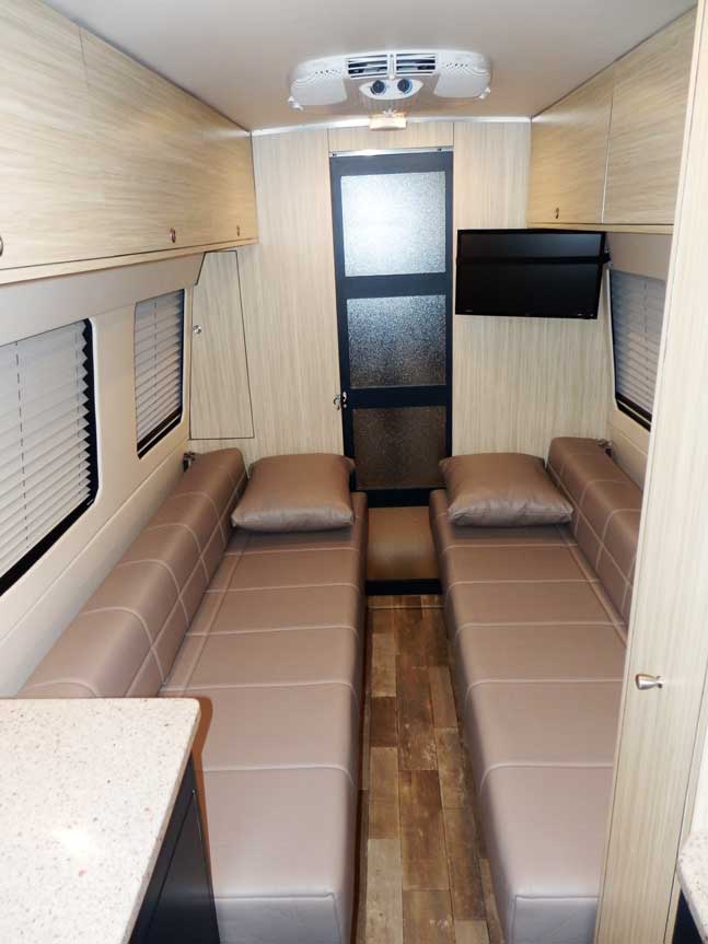 Inteior view of upgraded leather Gaucho seats in a custom Sportsmobile van conversion.