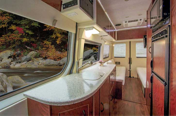 Inteior view of upgraded kitchen in a custom Sportsmobile van conversion.
