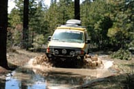 A Sportsmobile conversion travellng over creeks.
