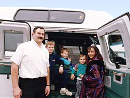 The Boydetts family next to their custom Sportsmobile van conversion.