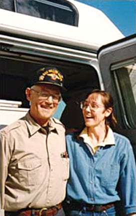 Dale and Sue Dalton standing next to their custom Sportsmobile van conversion.