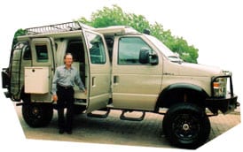 Jim Cunningham pictured next to his custom Sportsmobile conversion van.