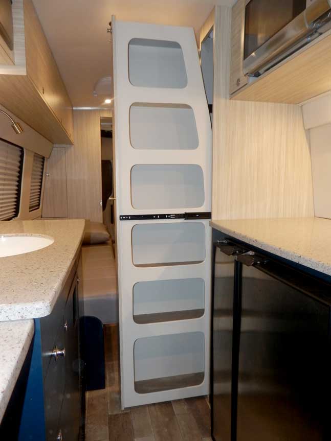 Inteior view of upgraded slide partition in a custom Sportsmobile van conversion.