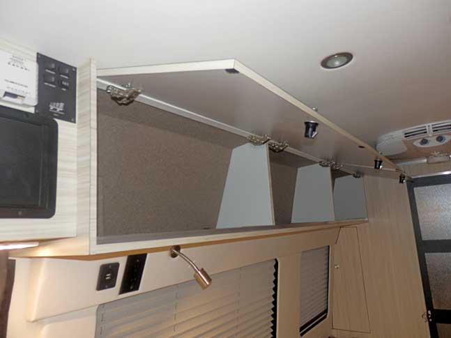Inteior view of upgraded upper cabinets in a custom Sportsmobile van conversion.