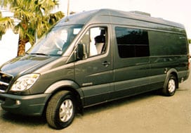 Profile view of a dark grey Sportsmobile van conversion with a fixed window.