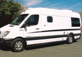Profile view of a white Sportsmobile van conversion with a small slider window.