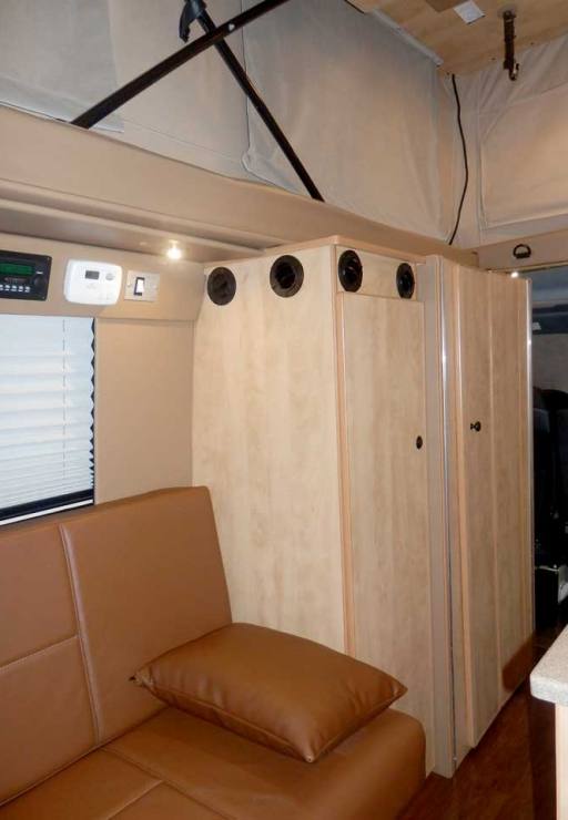 Transit camper conversion interior closet, storage drawers, and shelves.