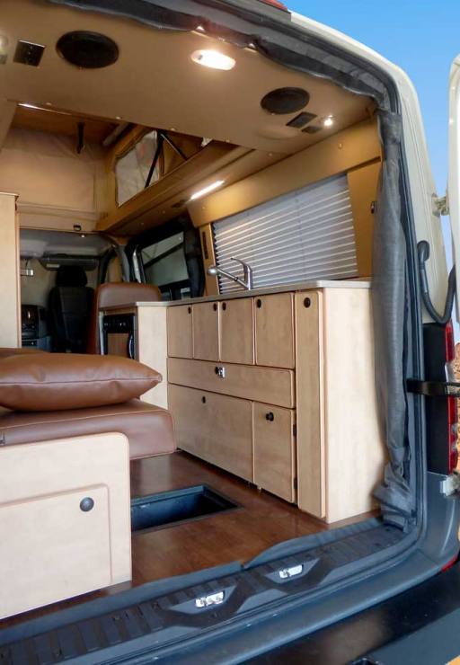 Transit camper conversion rear view of open storage space.