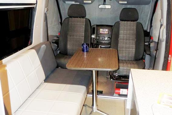 Van conversion with gaucho, table, and upgraded leather.