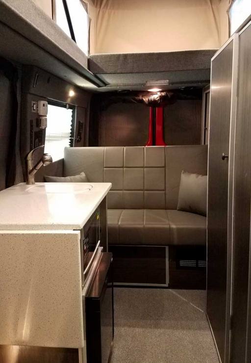 Custom Red RB-50M Sportsmobile Sprinter with leather couch.