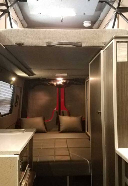 Custom Red RB-50M Sportsmobile Sprinter with a leather couch that flips into a bed.