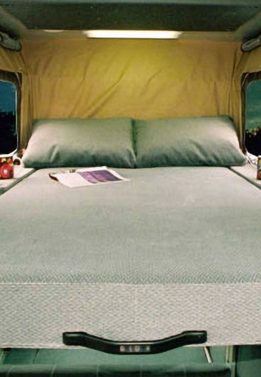 Penthouse bed sleeps 2 inside a custom Sportsmobile Sprinter RB 150M conversion van.