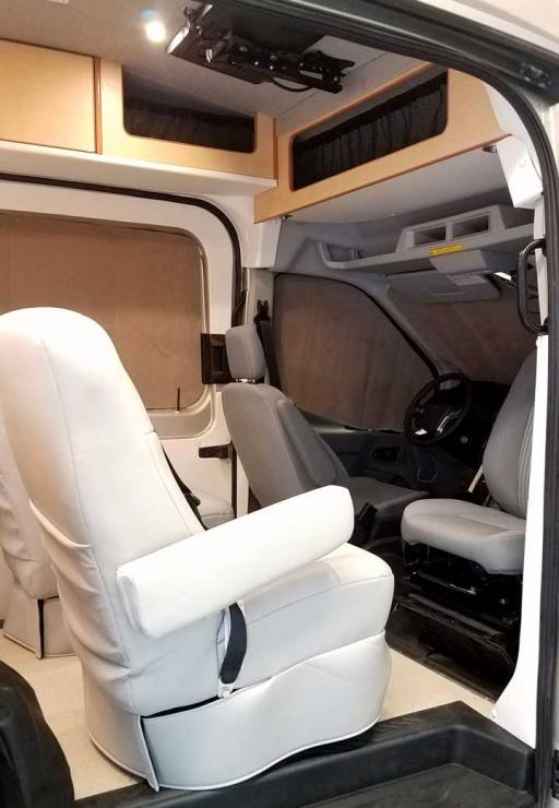 Interior view of a custom Sportsmobile Transit conversion van with captain seats.