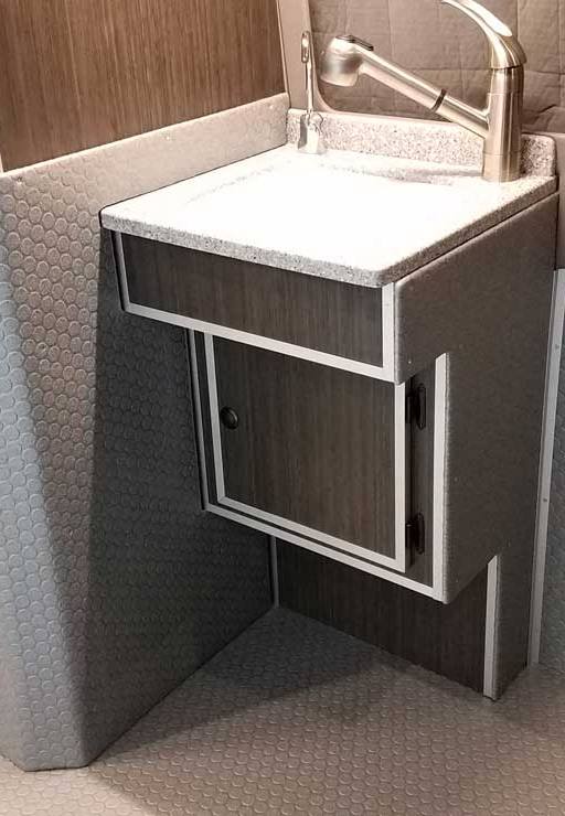 Interior view of a Sportsmobile Sprinter with interior sink.