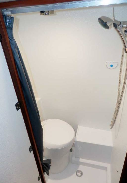 Interior view of a custom Sportsmobile Sprinter van conversion with a toilet and shower.
