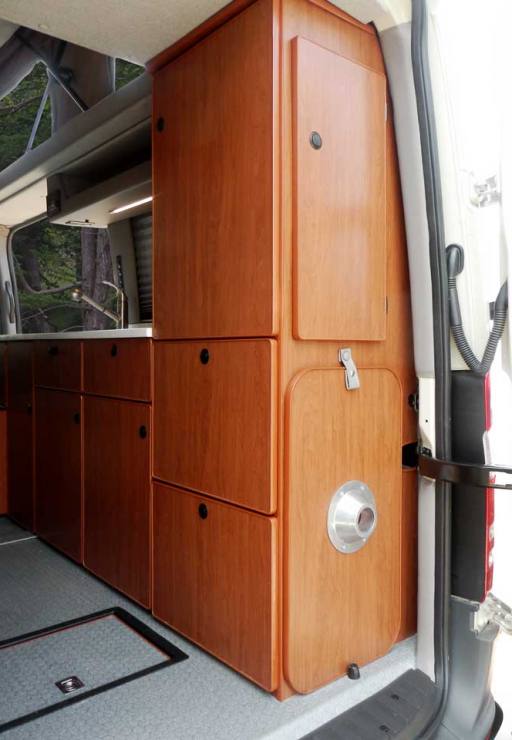 Interior view of a custom Sportsmobile Sprinter van conversion featuring special cabinets.
