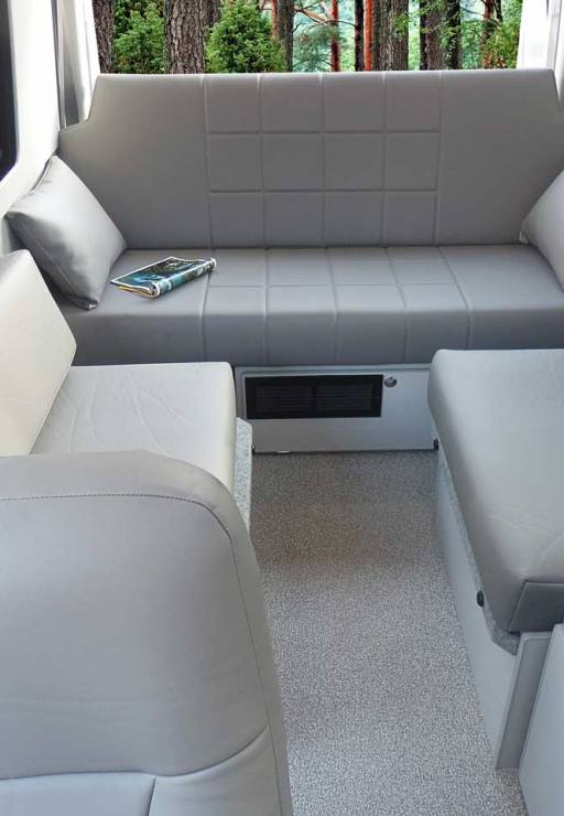 Custom Mercedes-Benz conversion van with couch and table.