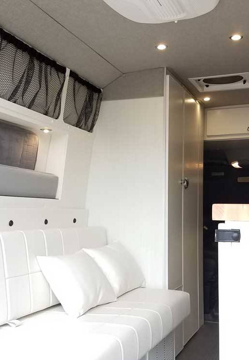 Custom Sprinter conversion van with white leather upholstery.