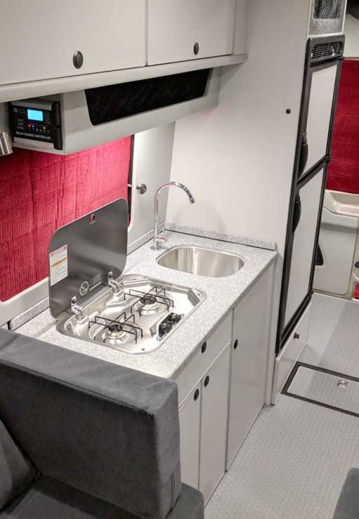 Propane stove, refrigerator, and microwave in the galley.